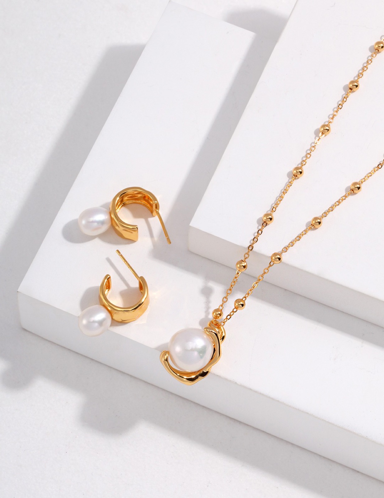 Sterling Pearl Huggies — Everyday huggie hoops with a natural pearl